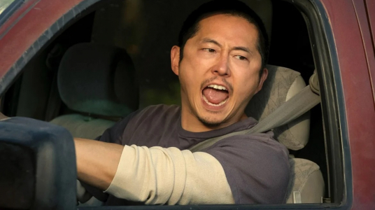 joven con rasgos asiáticos gritando por la ventanilla de un auto